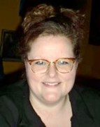 Smiling woman with brown hair and glasses